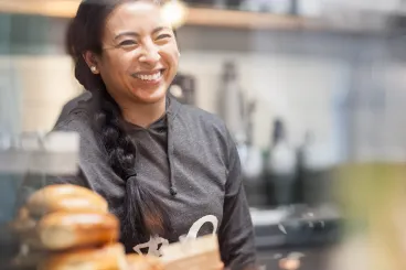 woman smiles from behind c