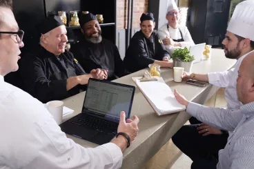 chefs make menu arrangements at a table