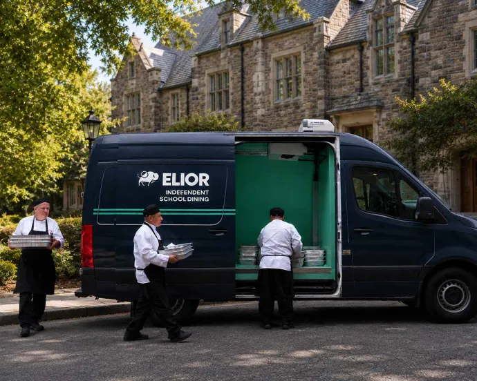 Three chefs carrying stacked food containers from a catering delivery van parked on a street, likely preparing for an event or meal service.