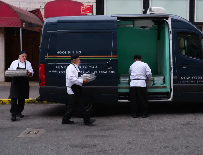 Chefs loading up sprinter van with food