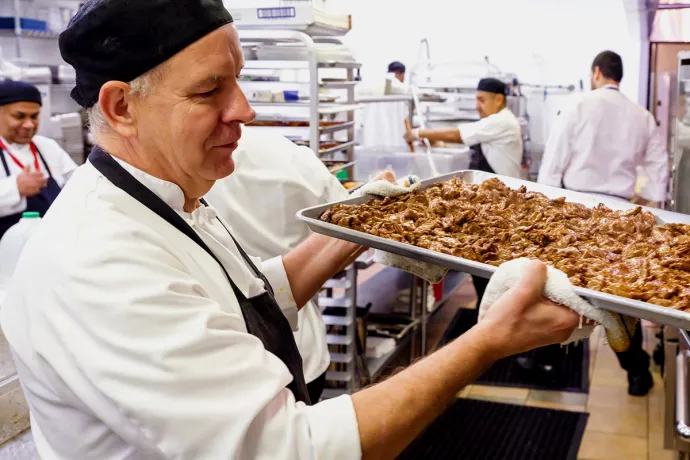 chef removing fresh cooked meat from the oven