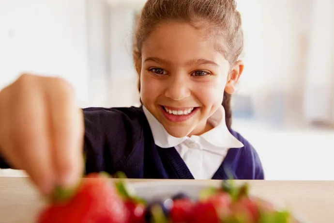 girl taking fresh strawberries